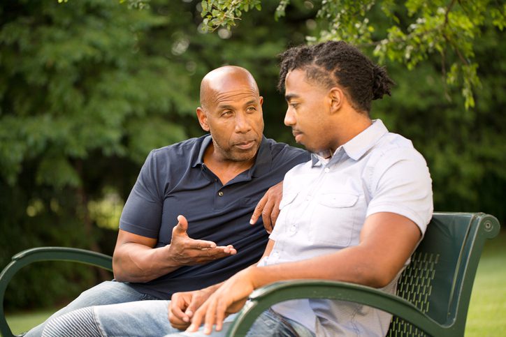 A father and son talking.