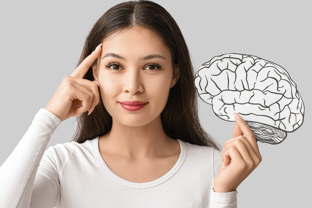 A woman holding up an image of a brain.